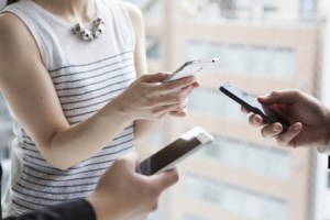 Three businessmen are communicating with smartphone